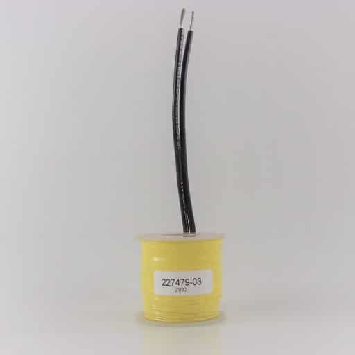 Yellow tape wrapped around wire coil, clear plastic caps on top and bottom, two black wire leads, label on front with part number 227479-03.