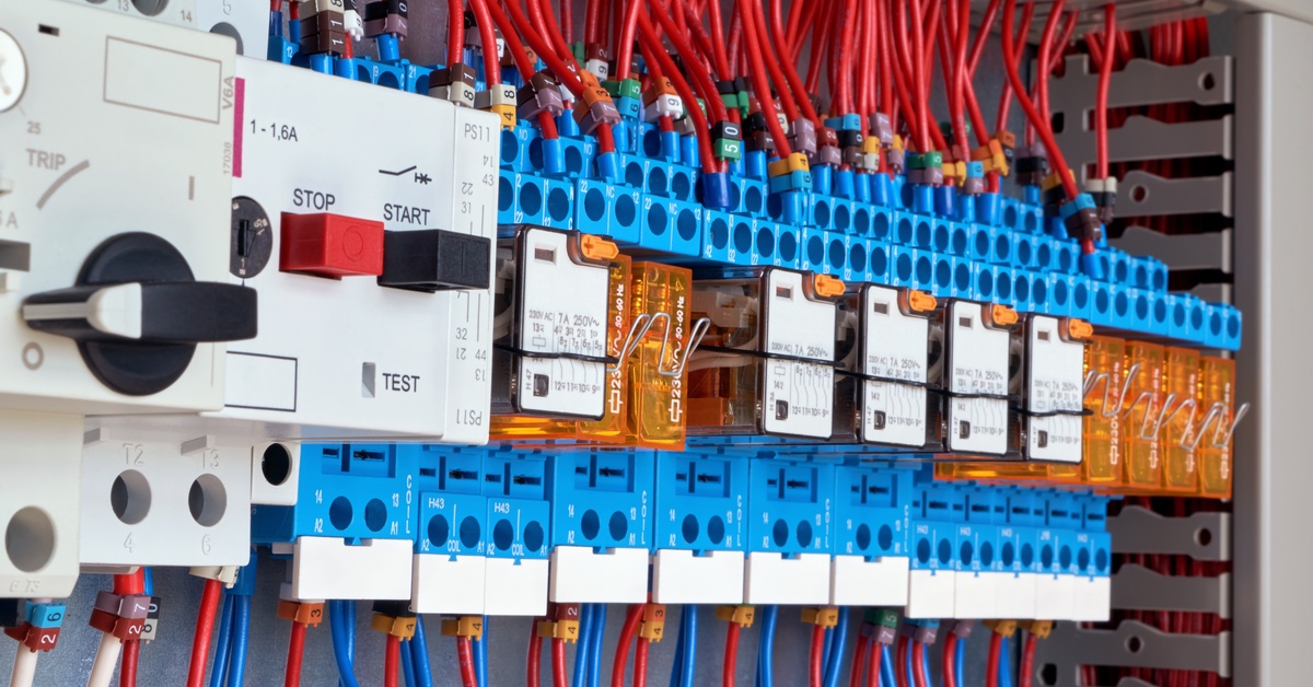 A close-up of an electrical cabinet feature cruit breaks and intermediate relays connecting to electrical equipment.