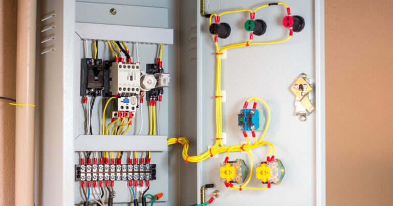 An electrical control panel with magnetic contactors, overload relays, and cartridge fuses on a main distribution board.